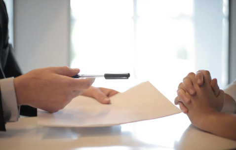 Business woman giving contract for signature